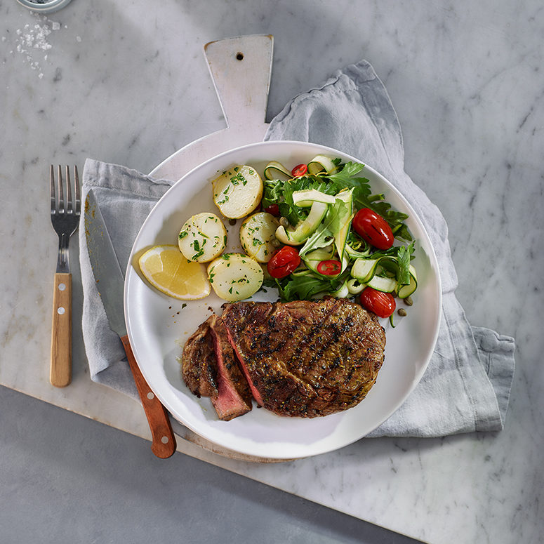 Scotch fillet with tomato and zucchini salad