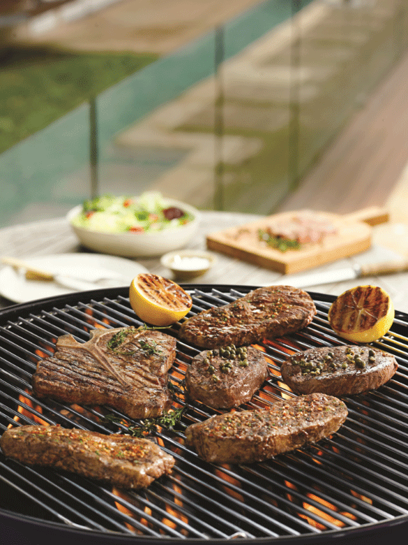 Barbecued T-bone steaks with herbs and peppercorns