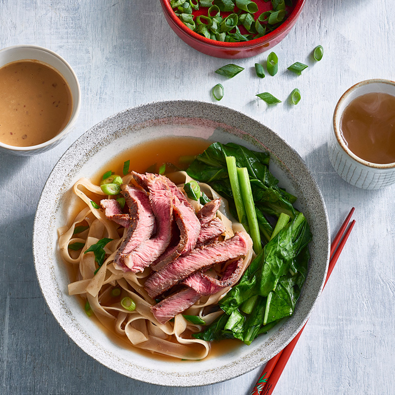 Beef noodle soup with Asian greens
