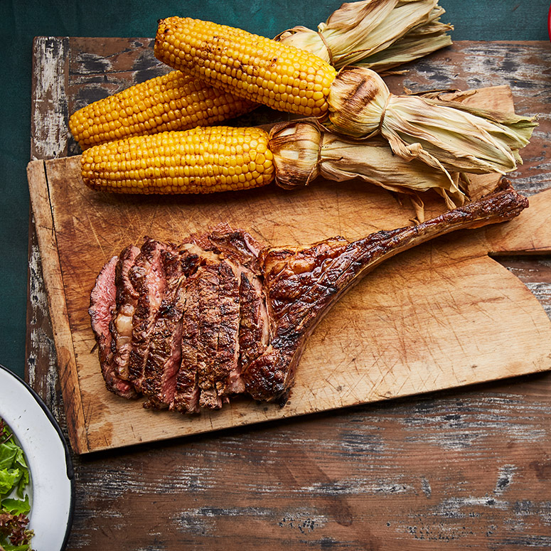 Tomahawk Steak with Potatoes, Corn and Asparagus